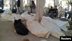 Bodies at a cemetery in the Qabon district of Damascus on July 22