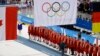 Olympic ice hockey players from Russia wear their gold medals under the Olympic flag during the 2018 Winter Olympics in Pyeongchang.