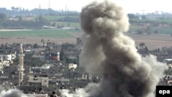 Smoke rises as an Israeli missile strikes in the east of Gaza City on January 8.