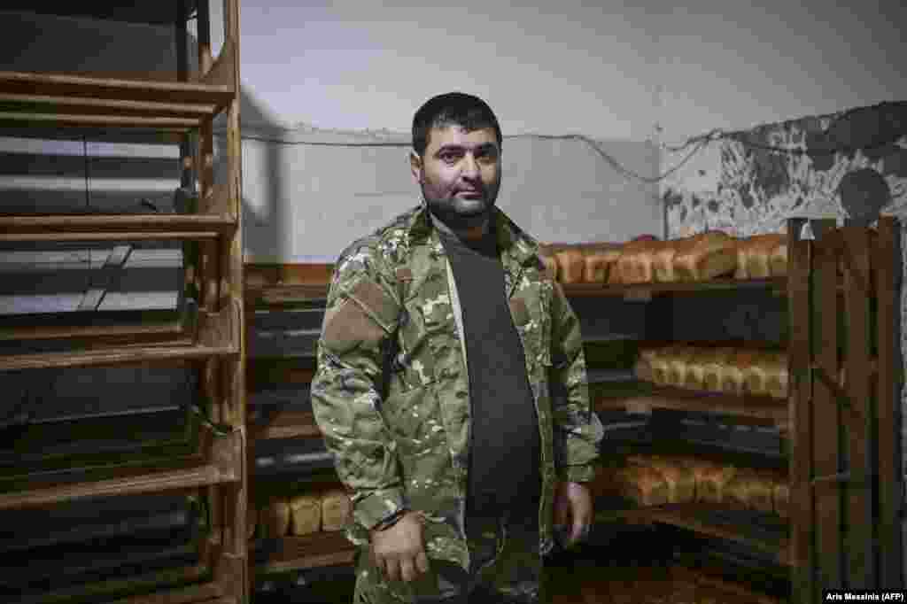 Armen Saghian, the 31-year-old owner of the bakery that now works nonstop to supply Stepanakert&#39;s ethnic Armenian community with free bread. Saghian says: &quot;From the first day of the war we decided to give [bread] to residents for free and to work for the army too.... We don&#39;t have financial problems. We get calls from institutions wanting to help us, but we don&#39;t need it. If it is the case, we will turn to them.&quot; Saghian did not disclose the source of funding for his bakery.