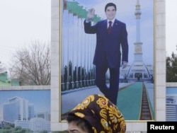 A campaign billboard displays a portrait of President Gurbanguly Berdymukhammedov in Ashgabat.