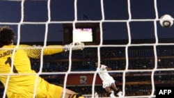 Ghana's Asamoah Gyan shoots past Serbia's Vladimir Stojkovic to score the game's only goal.