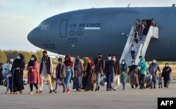 Refugees disembarked from a U.S. Air Force aircraft after an evacuation flight from Kabul at a naval base in Rota, southern Spain, in August 2021.