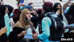 Afghans hold placards and shout anti-Pakistan slogans during a protest in Kabul on September 7.