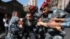 Police officers detain a demonstrator during a protest against Prime Minister Nikol Pashinyan in Yerevan on September 22.