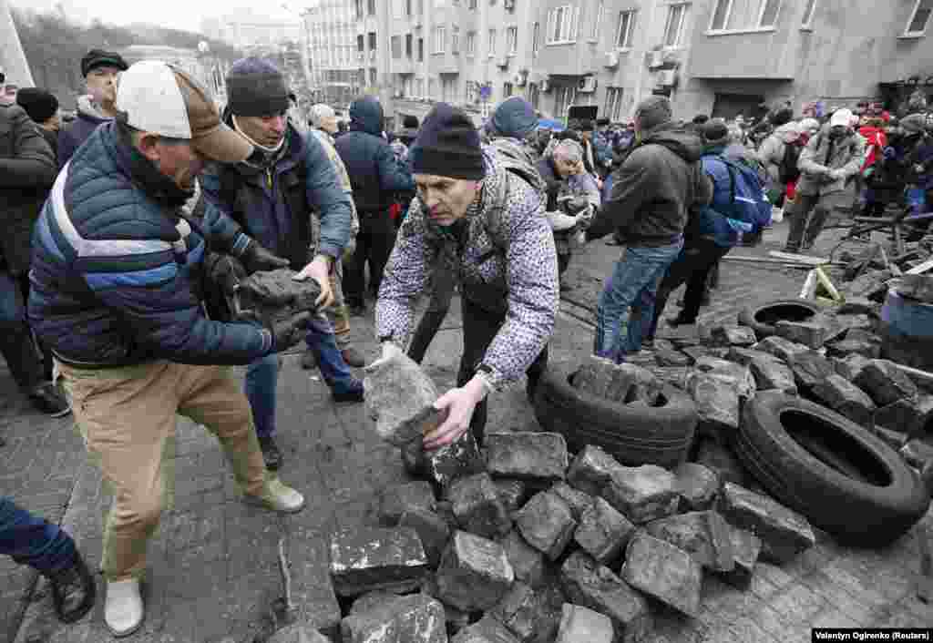 Protesters stack paving stones as the standoff grows.&nbsp;