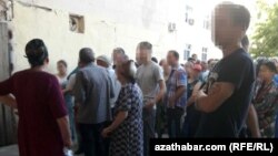 People wait for a chance to buy subsidized food at a state store in Ashgabat in 2019.