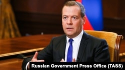 Russian Prime Minister Dmitry Medvedev speaks during an interview with Kommersant at the Gorki state residence outside Moscow on August 6.