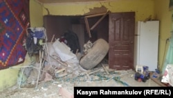 A wheel from the plane is seen inside a house.