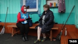 A census officer collects data from residents of the remote village of Ostrovnoye in Russia's Sverdlovsk region in April 2021. 