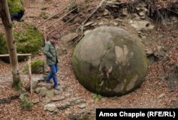 A man who runs a small cafe next to this stone sphere discovered in 2016 in a forest near the Bosnian town of Zavidovici.