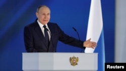 Russian President Vladimir Putin gives his speech to both houses of parliament in Moscow on April 21.