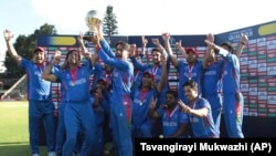 Afghan players celebrate after winning the trophy during their cricket world-cup-qualifier match against West Indies in Zimbabwe on March 25.