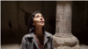 Armenia - visitors sing in a stone chapel at the Geghard monastery complex - underground cave church - screen grab