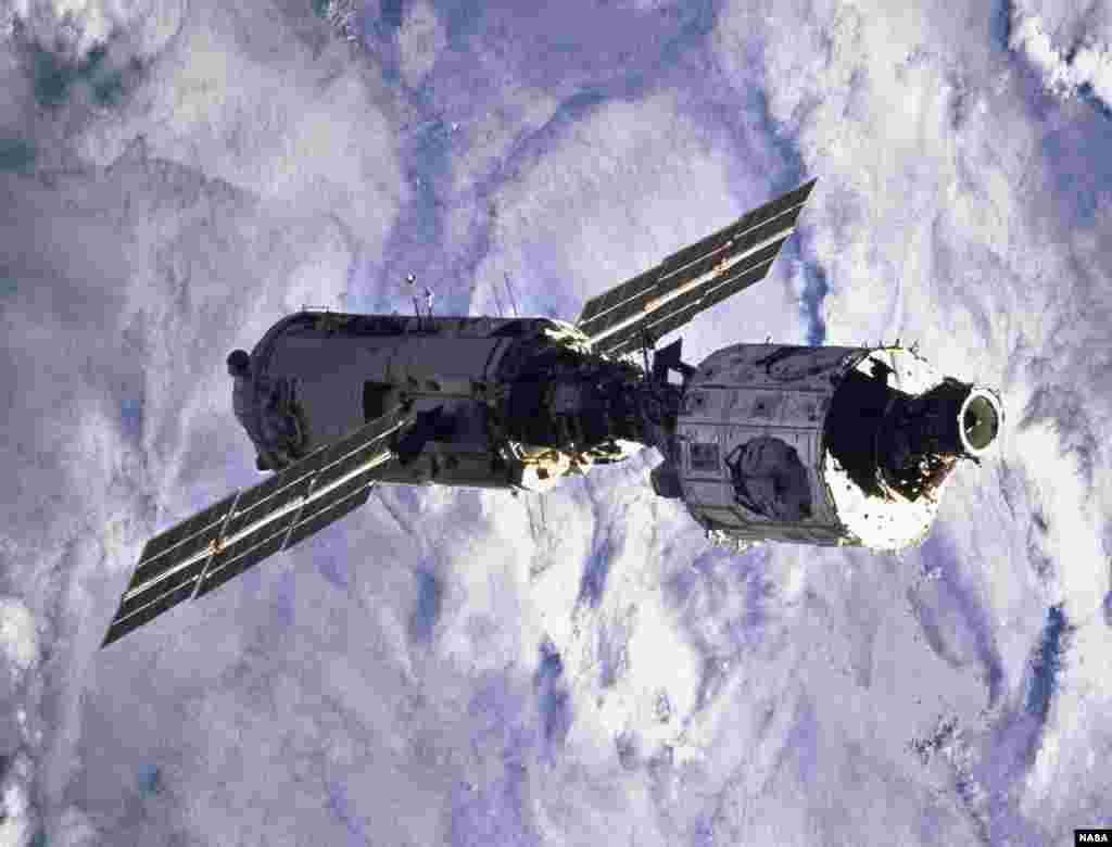 Blanketing clouds form the backdrop for this scene of the connected &quot;Zarya&quot; and &quot;Unity&quot; modules after having been released from the cargo bay of the space shuttle &quot;Endeavour&quot; a bit earlier.