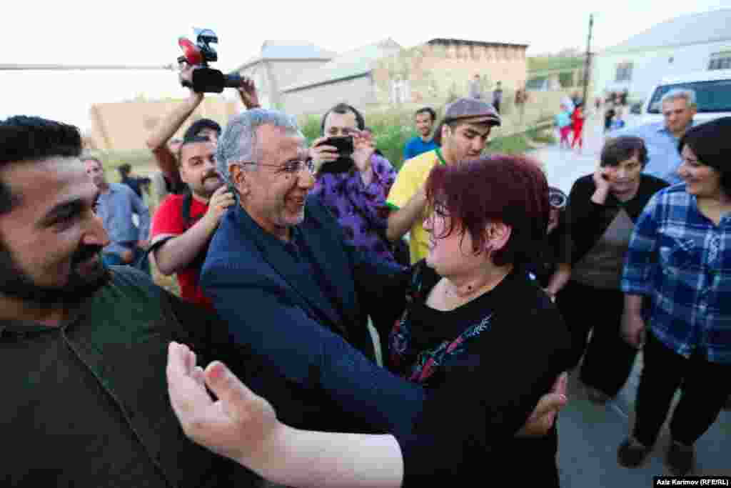 Ismayilova is greeted by Intigam Aliyev, a human rights lawyer released from prison on March 28 after his 7 1/2-year sentence was commuted.