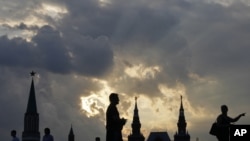 The sun sets on Red Square near the Kremlin.