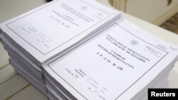 Volumes of declassified information lay on a table during the ceremony in Moscow on April 7.