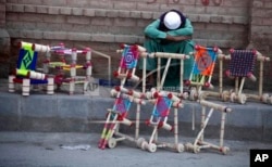 A carpenter waits for customers on the side of a road in Peshawar during a government-imposed nationwide lockdown against the pandemic in April 2020.