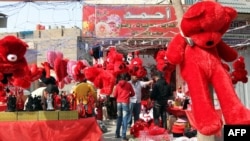 Huge red bears and other soft toys are prominently displayed for sale by a vendor on Valentine's Day in Baghdad.