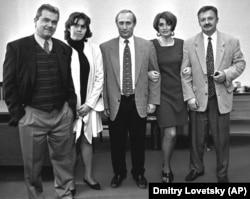 Vladimir Putin (center), then Russian President Boris Yeltsin's deputy chief of staff, poses with friends at a party in St. Petersburg in February 1997.