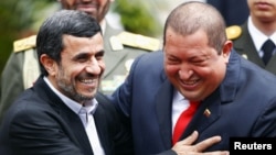 Iran's President Mahmud Ahmadinejad (left) is welcomed by Venezuela's President Hugo Chavez in Caracas in January 2012.