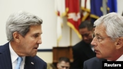 U.S. Secretary of State John Kerry (left) speaks with Defense Secretary Chuck Hagel before testifying at the House Armed Services Committee in Washington on September 10.