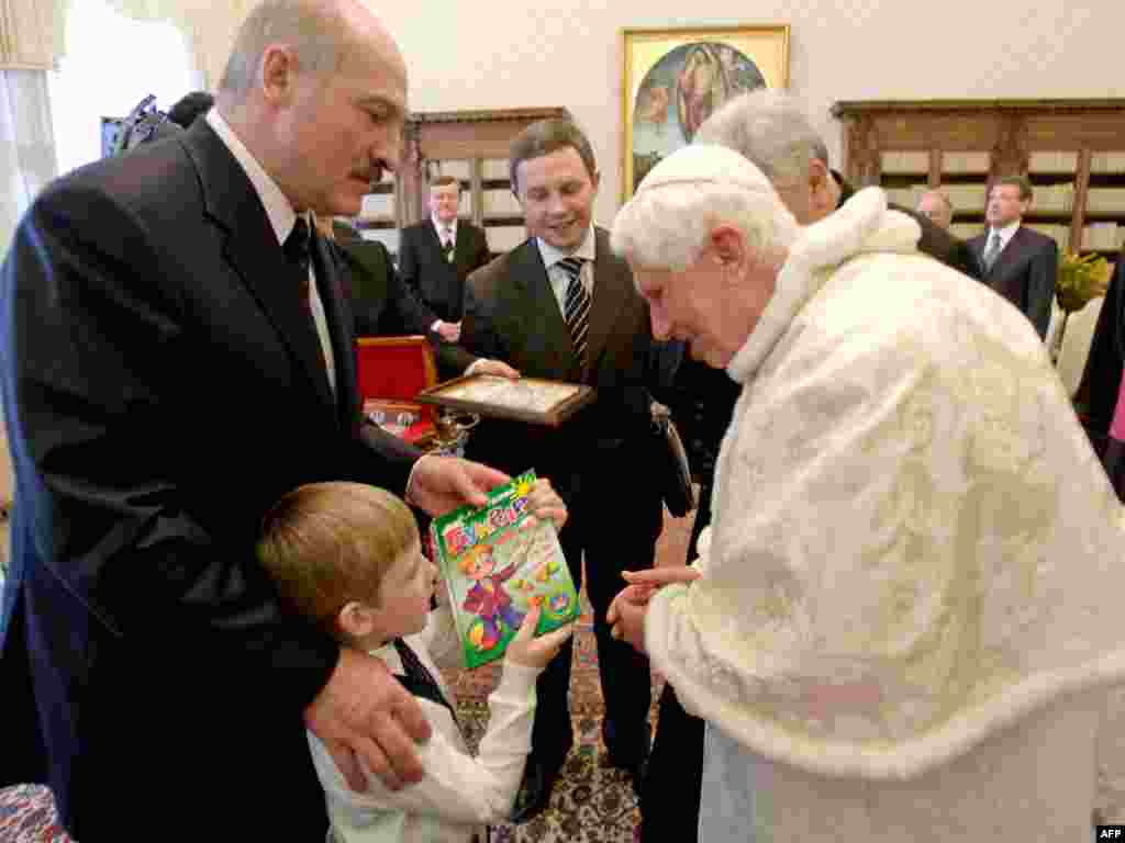 Kolya offers a Russian-language alphabet book to Pope Benedict during the meeting at the Vatican.