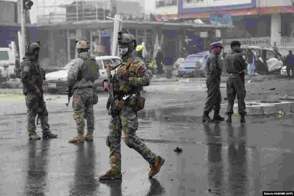 Members of the Afghan security forces inspect at the site of the attack.