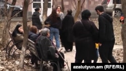 People wait anxiously in a courtyard in Yerevan after an earthquake on February 13.