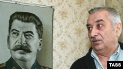 Yevgeny Dzhugashvili with a portrait of his grandfather