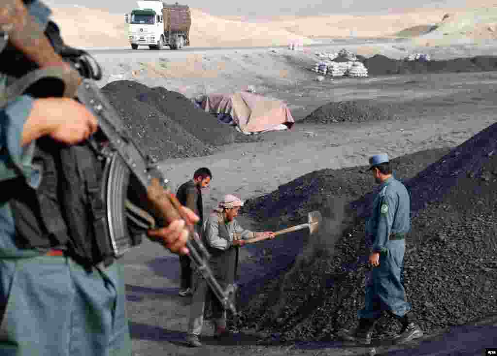 Police guard the entrance to the collapsed mine in Samangan.