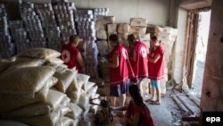 International Committee of the Red Cross workers enter a storehouse to check products after a Ukrainian convoy delivered humanitarian aid for eastern Ukrainian regions, in the town of Starobilsk, in August 2014.