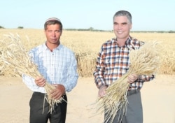 Turkmen President Gurbanguly Berdymukhammedov (right) visited the Lebap Province in June in a trip extensively covered by state media.