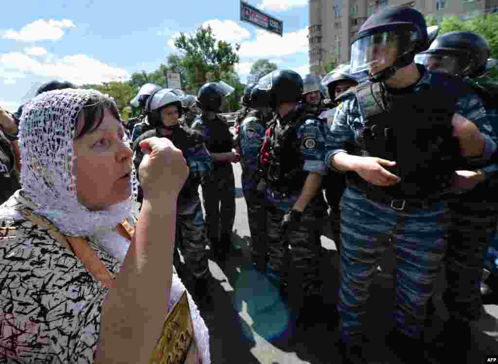 An Orthodox adherent remonstrates with police as she and others protest against the gay-rights march.&nbsp;