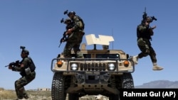 Afghan soldiers patrol outside their military base on the outskirts of Kabul on May 9.