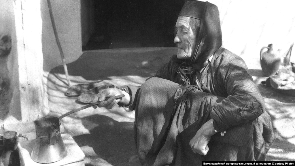 A woman makes coffee in Bakhchysaray during the 1920s. Coffee is central to Crimean Tatar cuisine and the culture as a whole. Every house had a coffee pot on the table. By the end of the 19th century, there were 62 coffee houses in Bakhchysaray.