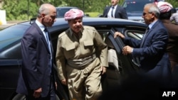 Kurdish leader Masud Barzani (center) has kept up a barrage of public statements suggesting the Kurdish region is now ready to move swiftly toward statehood. But is it?