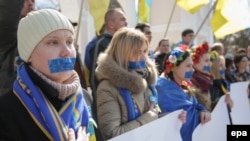 Ukrainians stand with taped mouths during their rally in Simferopol, Crimea. 