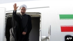 Iranian President Hassan Rohani waves before departing for the United States to attend the UN General Assembly on September 23