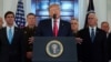 U.S. President Donald Trump delivers a statement about Iran flanked by U.S. Secretary of Defense Mark Esper (far left), Vice President Mike Pence (far right) and military leaders in the Grand Foyer at the White House in Washington on January 8. 