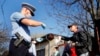 A Romanian police officer checks the travel documents of a man on the southern outskirts of Bucharest on April 3.