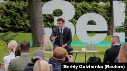 Ukrainian President Volodymyr Zelenskiy gestures during an open-air news conference in Kyiv on May 20.