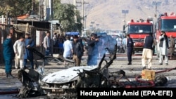 Afghan security forces inspect the site of a blast in Kabul on October 27.