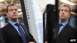 Russian President Dmitry Medvedev adjusts his jacket during a visit to Russian IT-manufacturing company Kraftway, in Obninsk, in April 2010.