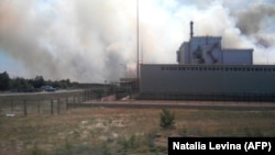 Smoke from nearby forest fires rises near the Chernobyl nuclear power plant on June 4.