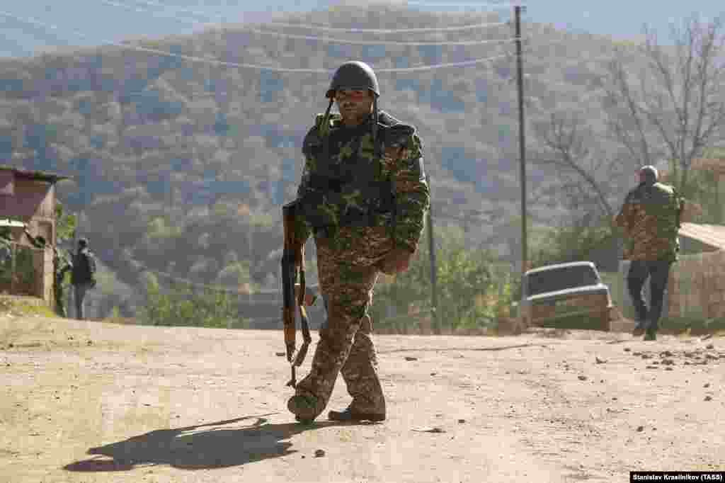 A militiaman walks on an empty road in Avetarnots, 14 kilometers from Stepanakert, the largest city in Nagorno-Karabakh.