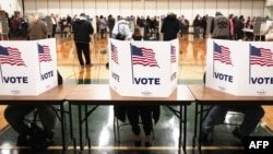 U.S. citizens vote in the presidential election at Carleton Middle School in Sterling Heights, Michigan.