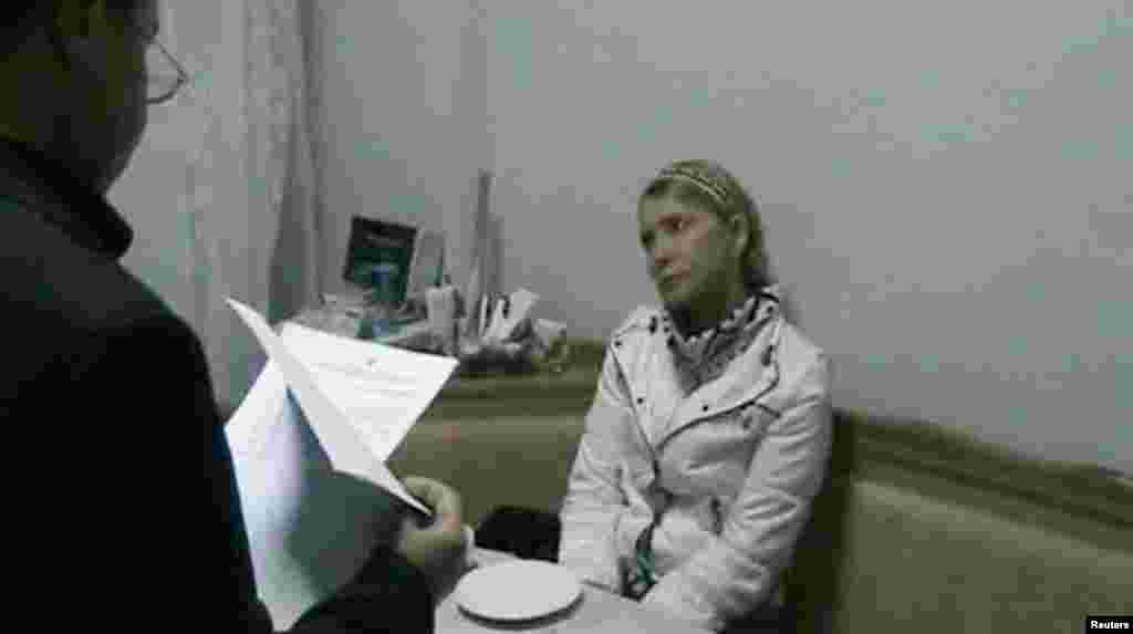 Tymoshenko is served with legal papers outlining new accusations against her by Kachanivska Prison Director Ihor Karpaschikov in her hospital room in Kharkiv in January 2013.