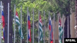 Russian and Abkhaz flags flying in front of Abkhazia's government headquarters in Sukhumi.